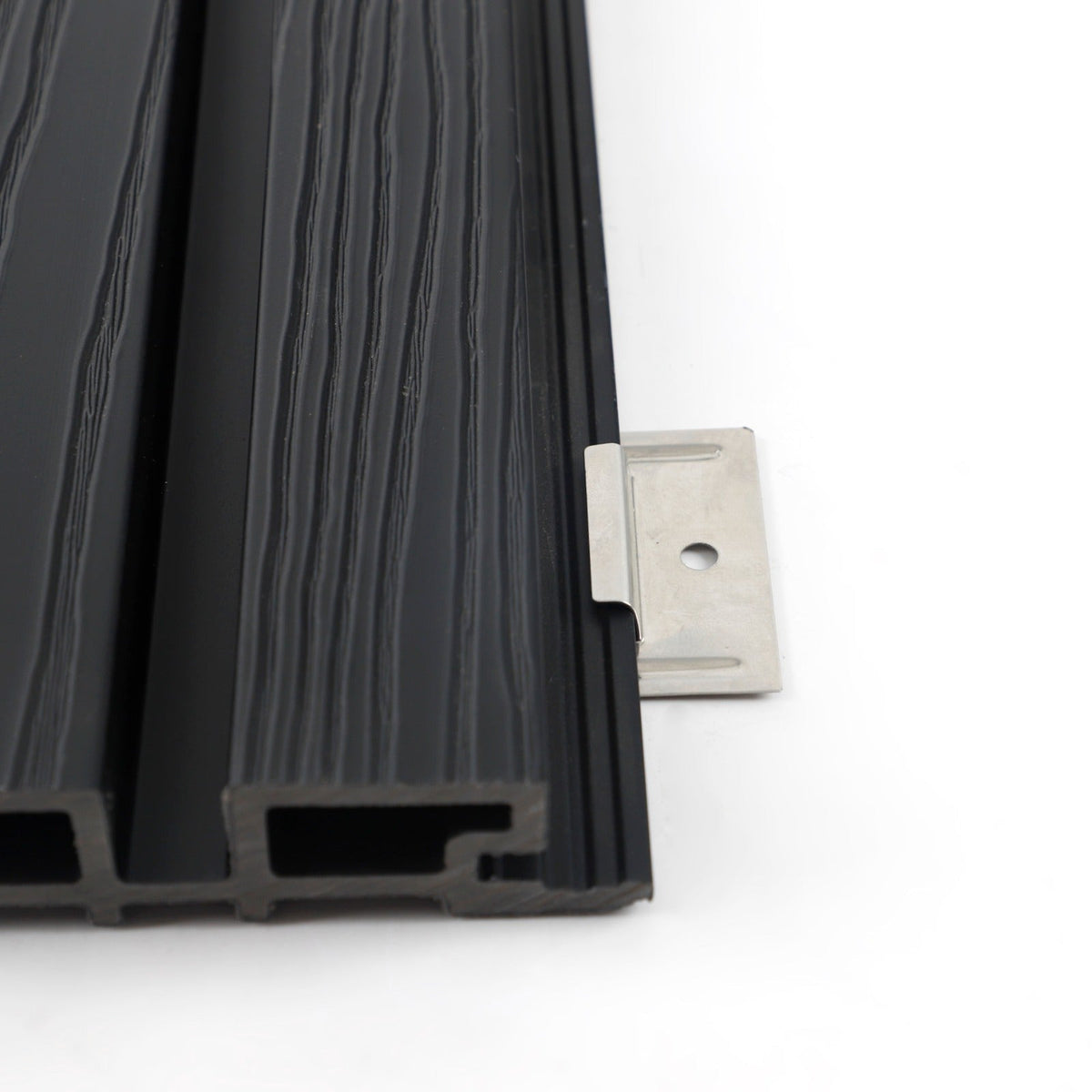 End view of hollow black composite cladding with a stainless steel installation bracket at the side