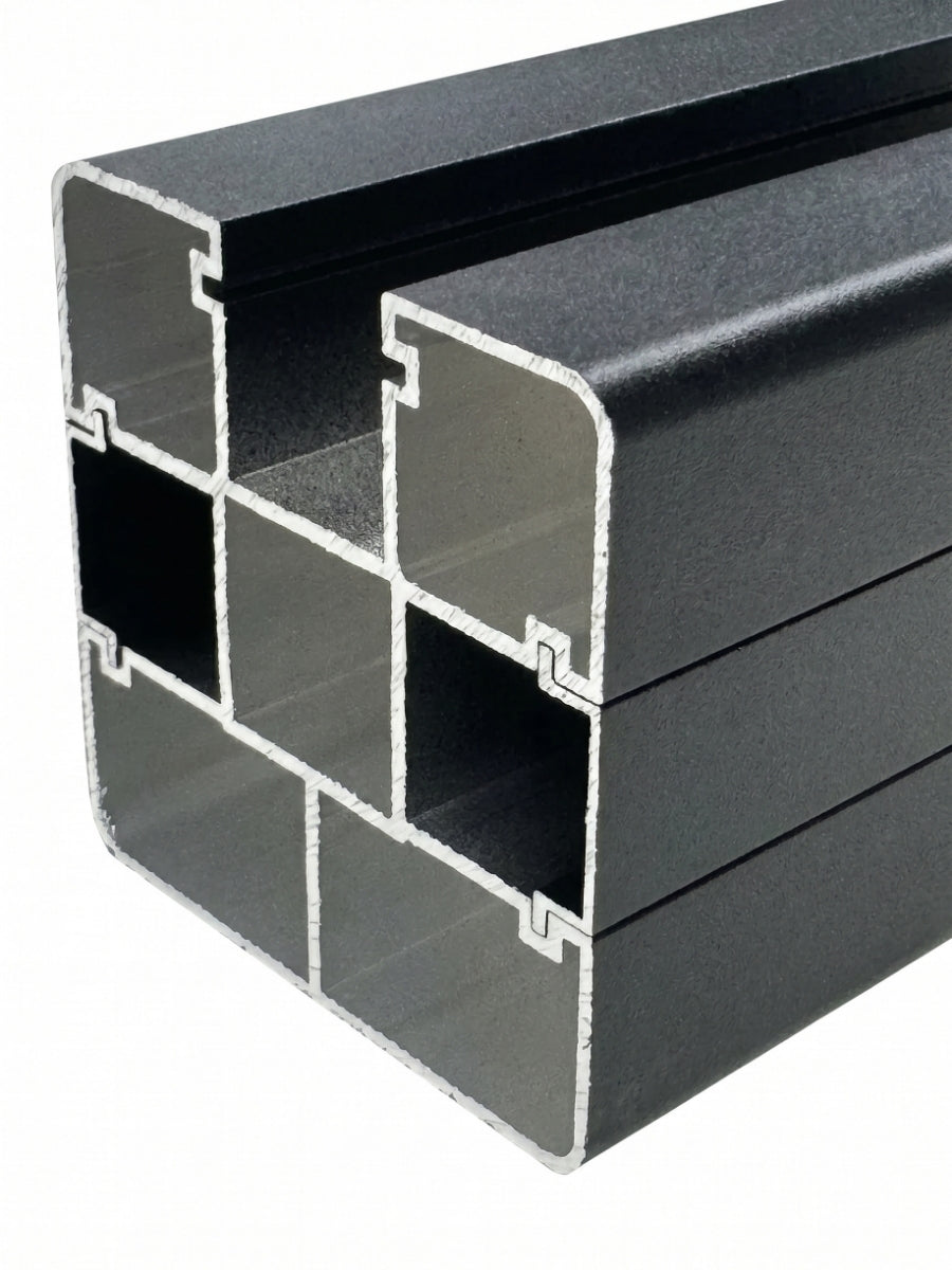 Close-up cross-section of the black in-ground fence post showing its hollow multi-channel profile