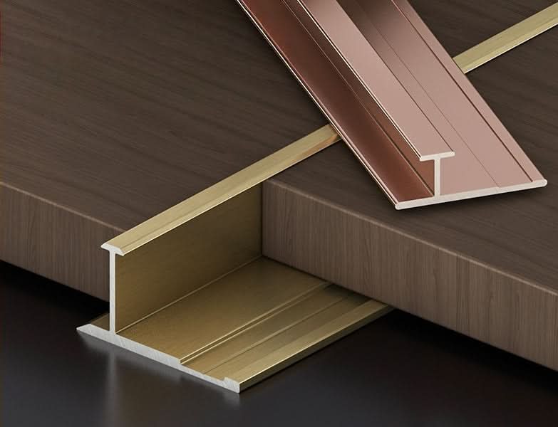 Aluminum wall panel T trim profiles in gold and bronze finishes for seamless panel joint finishing