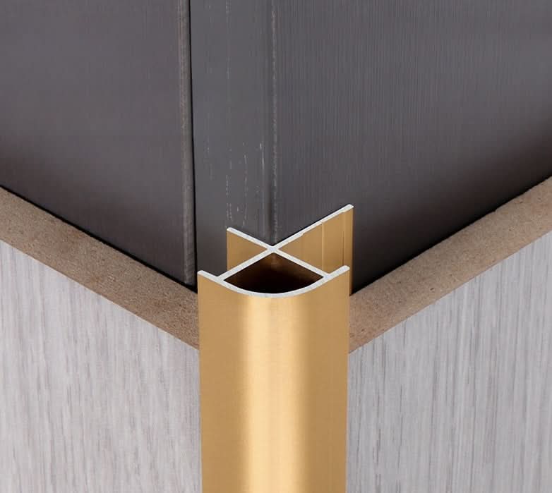 Gold aluminum wall panel outside corner trim installed for clean and durable corner edge finishing