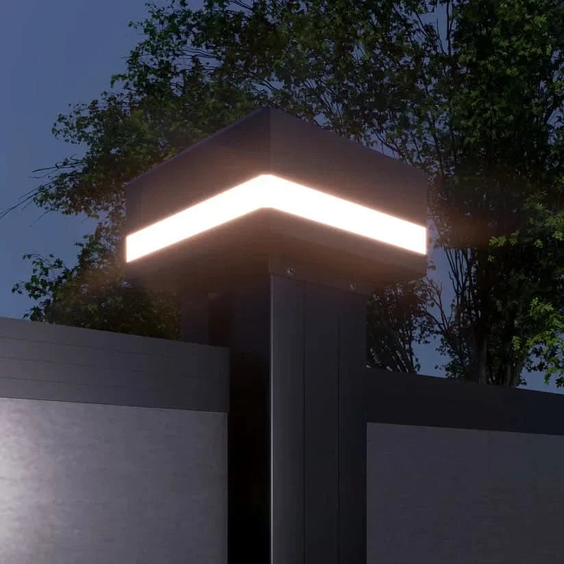 “LED fence post cap with integrated chevron light on black aluminum fence”
