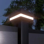 “LED fence post cap with integrated chevron light on black aluminum fence”