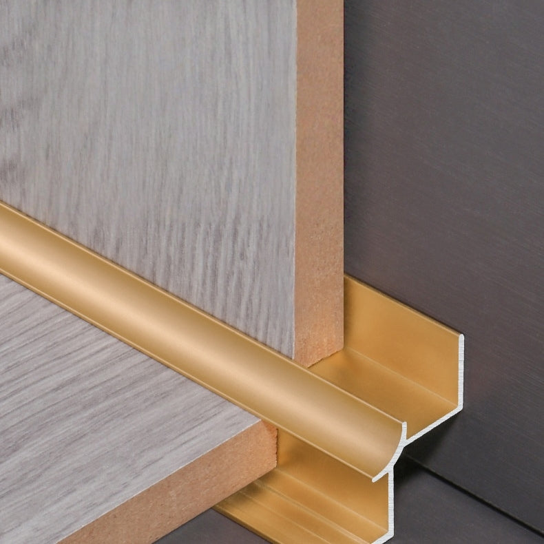 Gold aluminum inside corner trim positioned between wood-look panel samples