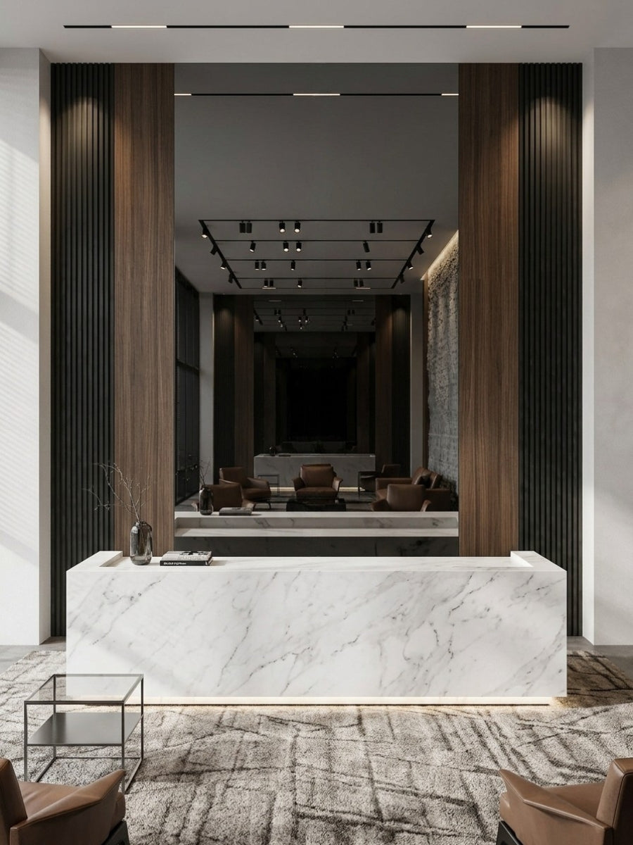 Black Mirror Wood Veneer Panel behind a marble reception desk, bordered by dark fluted and warm wood panels