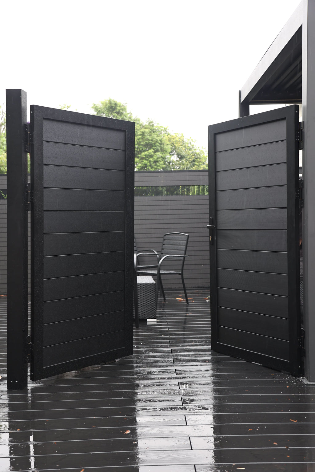 Black aluminum double privacy fence gate fully open with horizontal slat panels