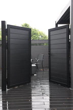 Black aluminum double privacy fence gate fully open with horizontal slat panels