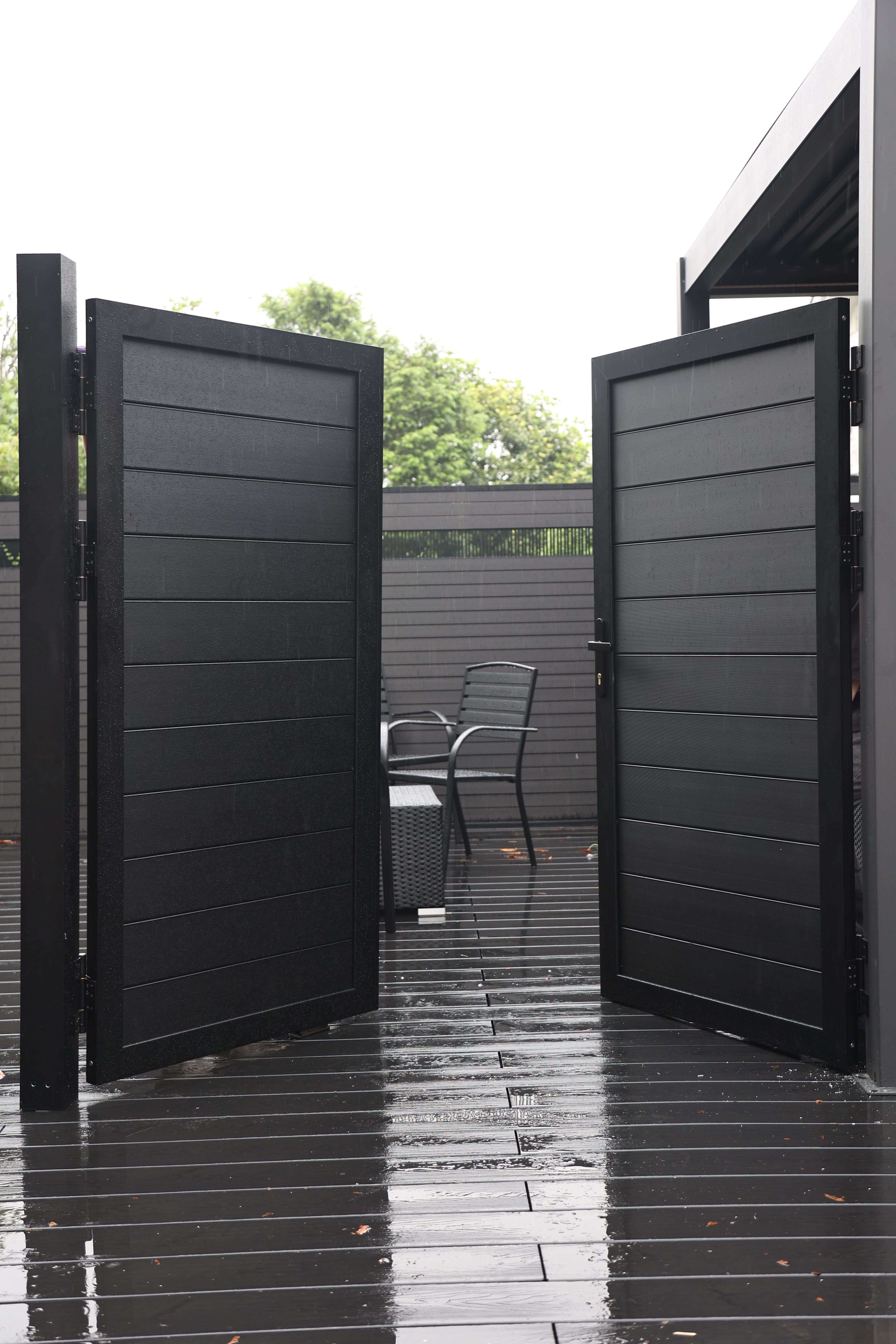 Black aluminum double privacy fence gate fully open with horizontal slat panels
