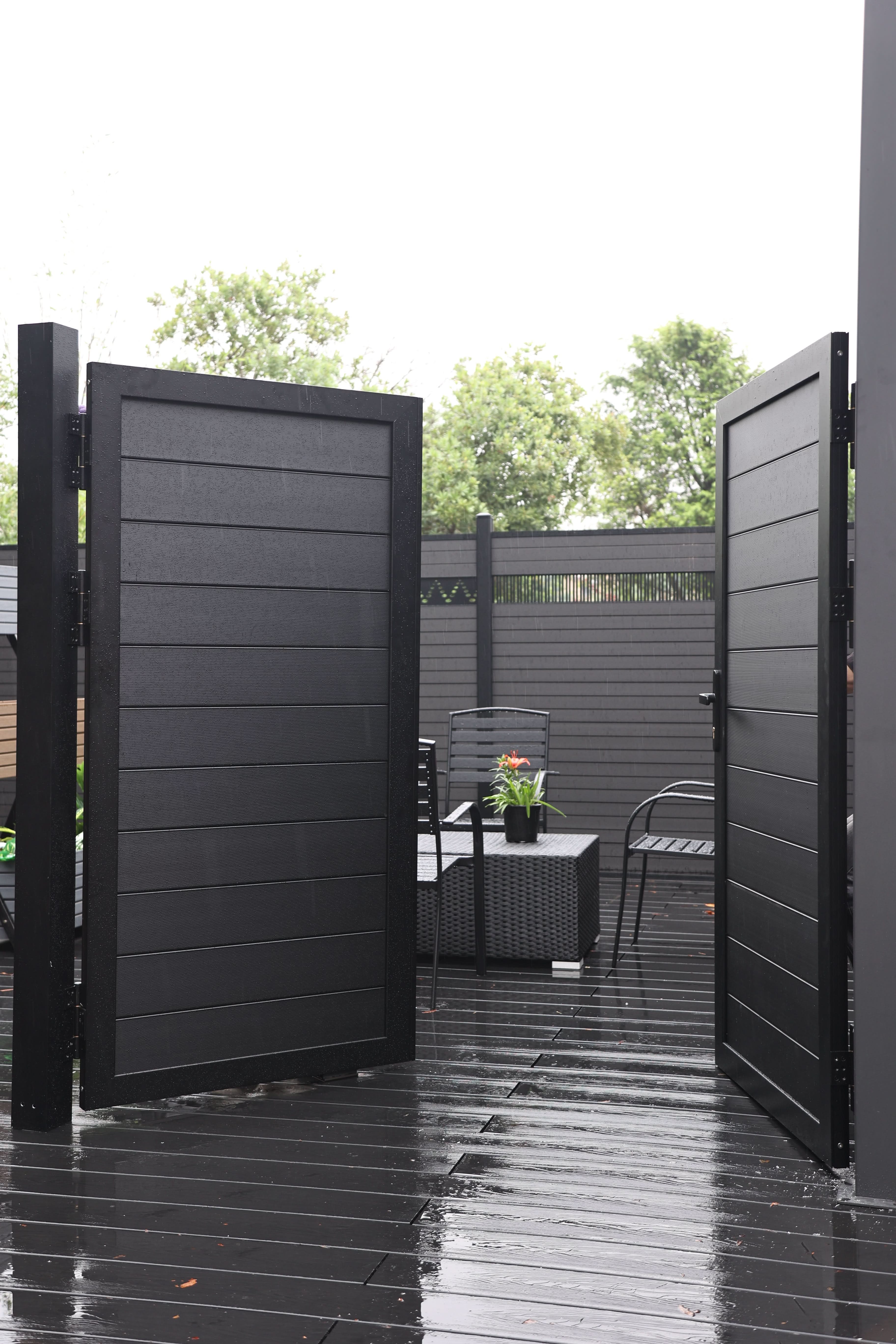 Black aluminum double privacy fence gate open inward with horizontal slat panels