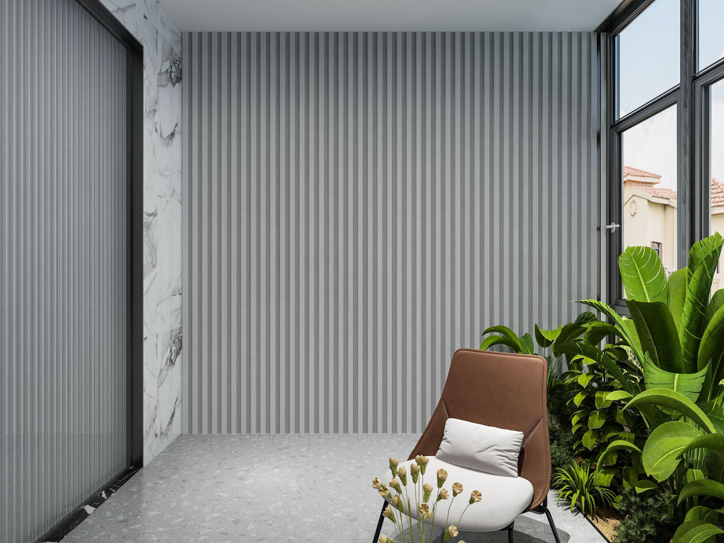 Gray fluted wall panels installed on modern interior accent wall with indoor plants and seating area