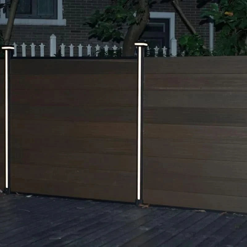 Composite privacy fence with vertical LED post lights installed between fence panels at night Main image