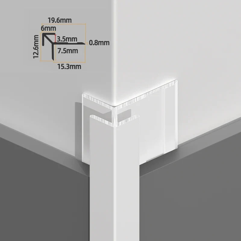 Silver sharp-edge aluminum outside corner trim installed on a panel corner with profile dimensions
