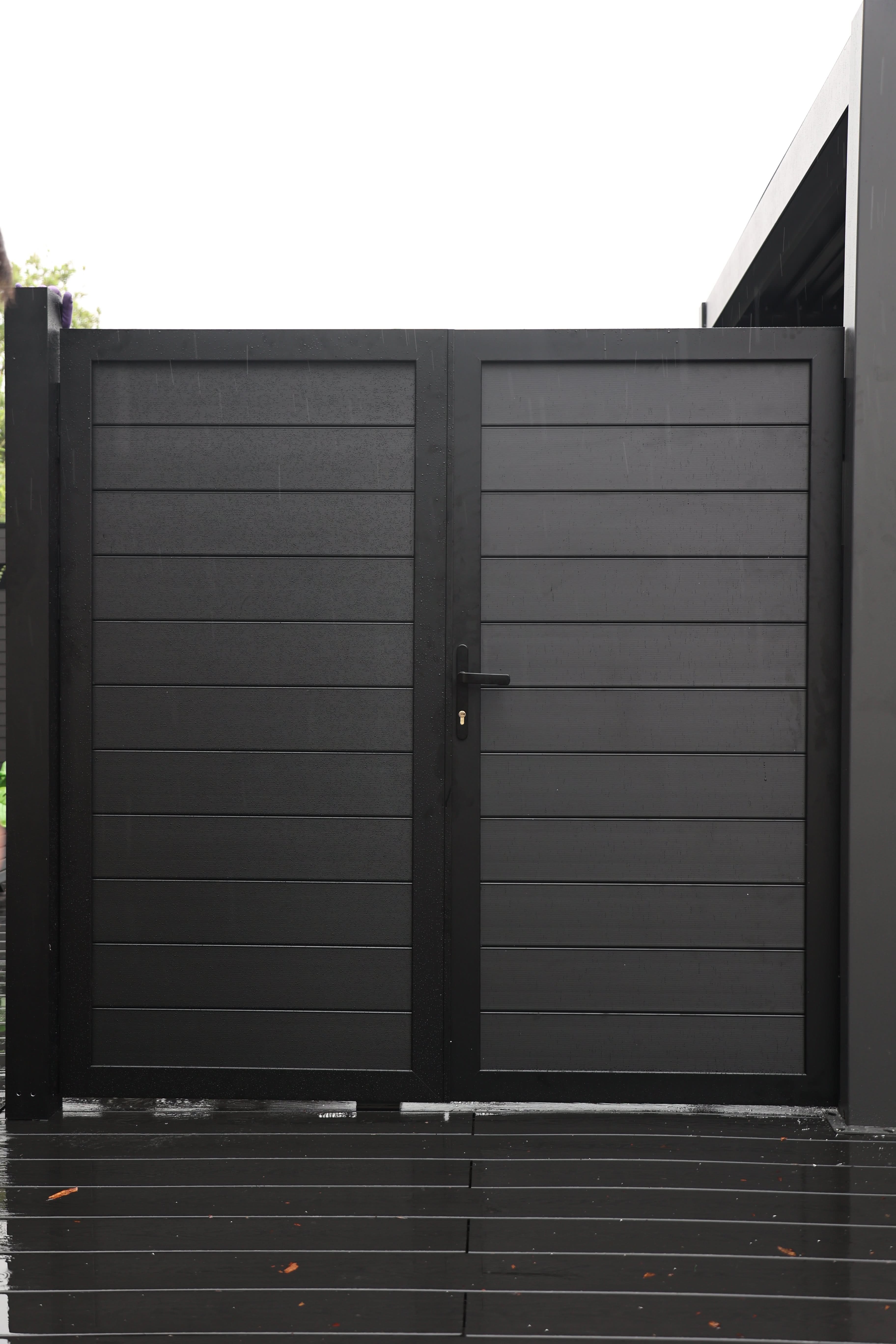 Black aluminum double privacy fence gate with horizontal panels and modern design