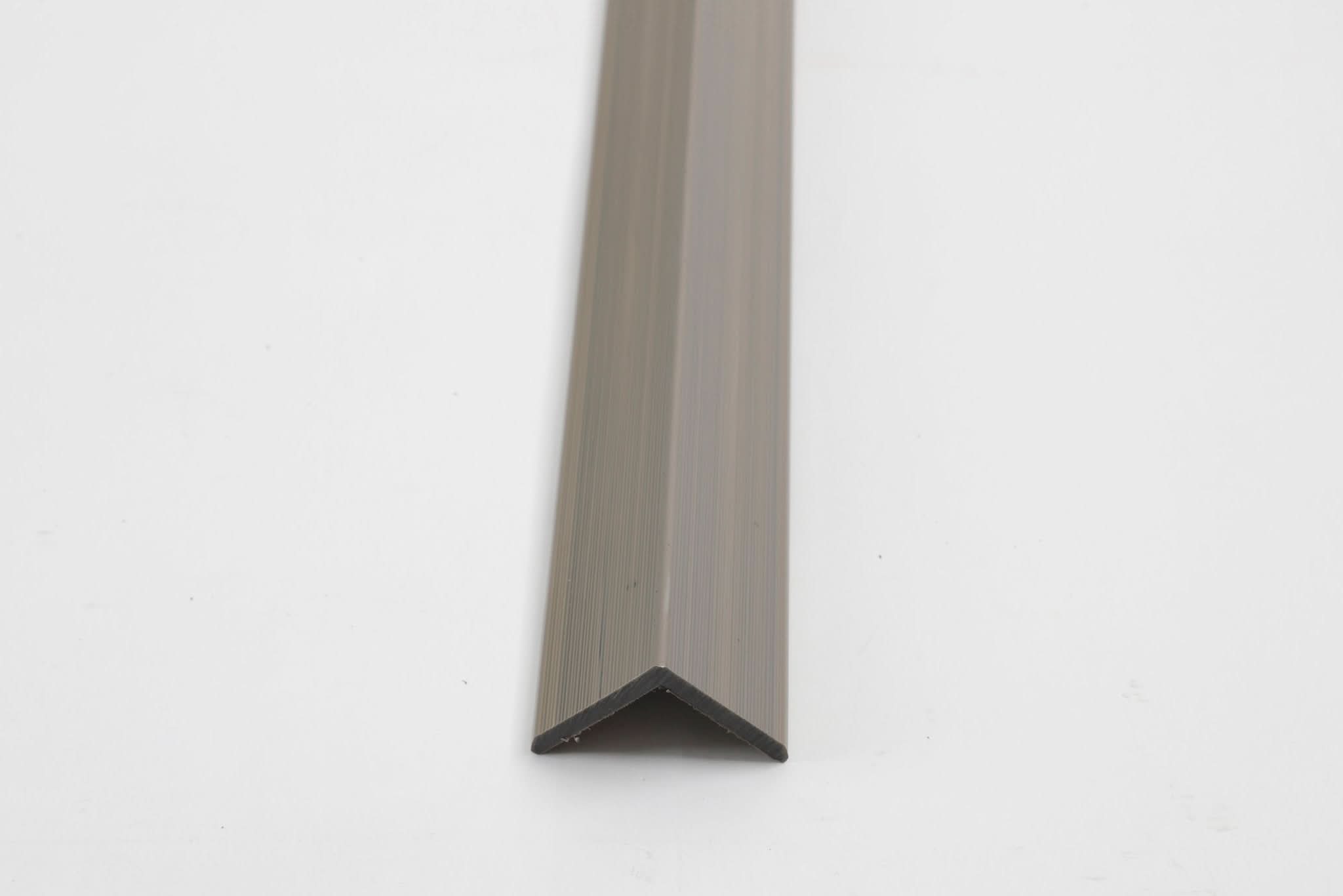 Champagne aluminum corner trim for wall panels with clean angled edge finish