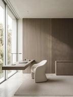Natural ash wood veneer wall panels forming a vertically textured accent wall in a modern home office