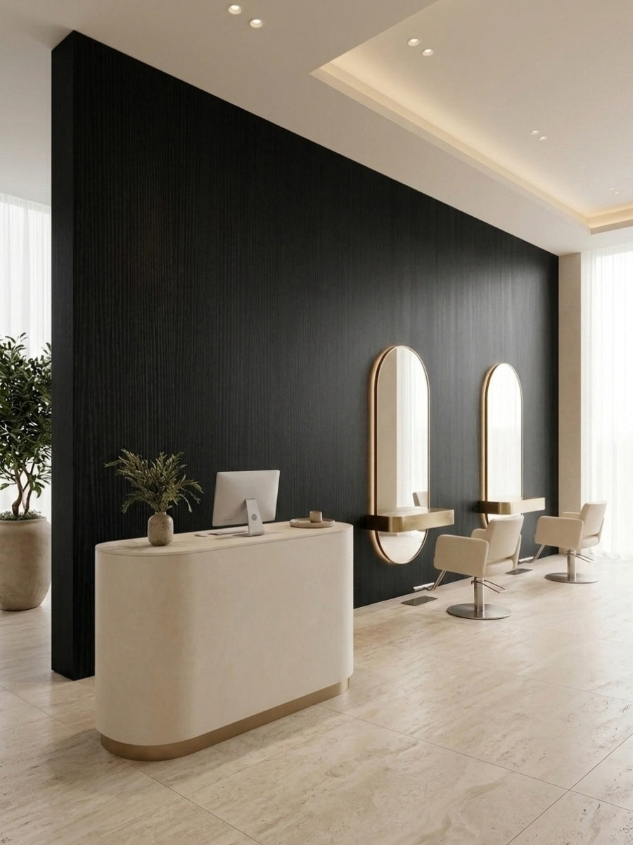 Blackwood veneer commercial wall panels installed behind a reception desk and styling stations