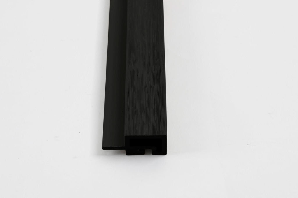 Black composite trim end view with wood grain texture and concealed channel