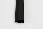 Black composite trim end view with wood grain texture and concealed channel