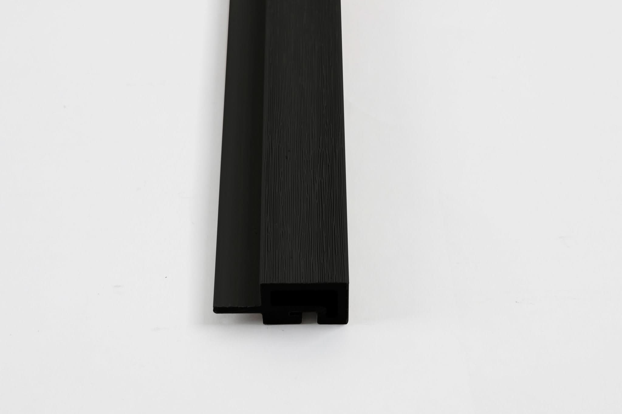 Black composite trim end view with wood grain texture and concealed channel
