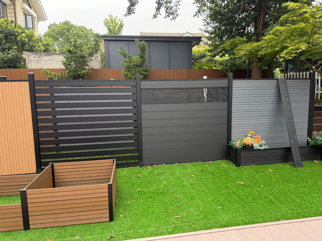 Modern composite fence display with gray and black horizontal panels installed in residential garden