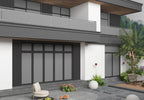 Modern home exterior with dark gray composite wide cladding panels and balcony