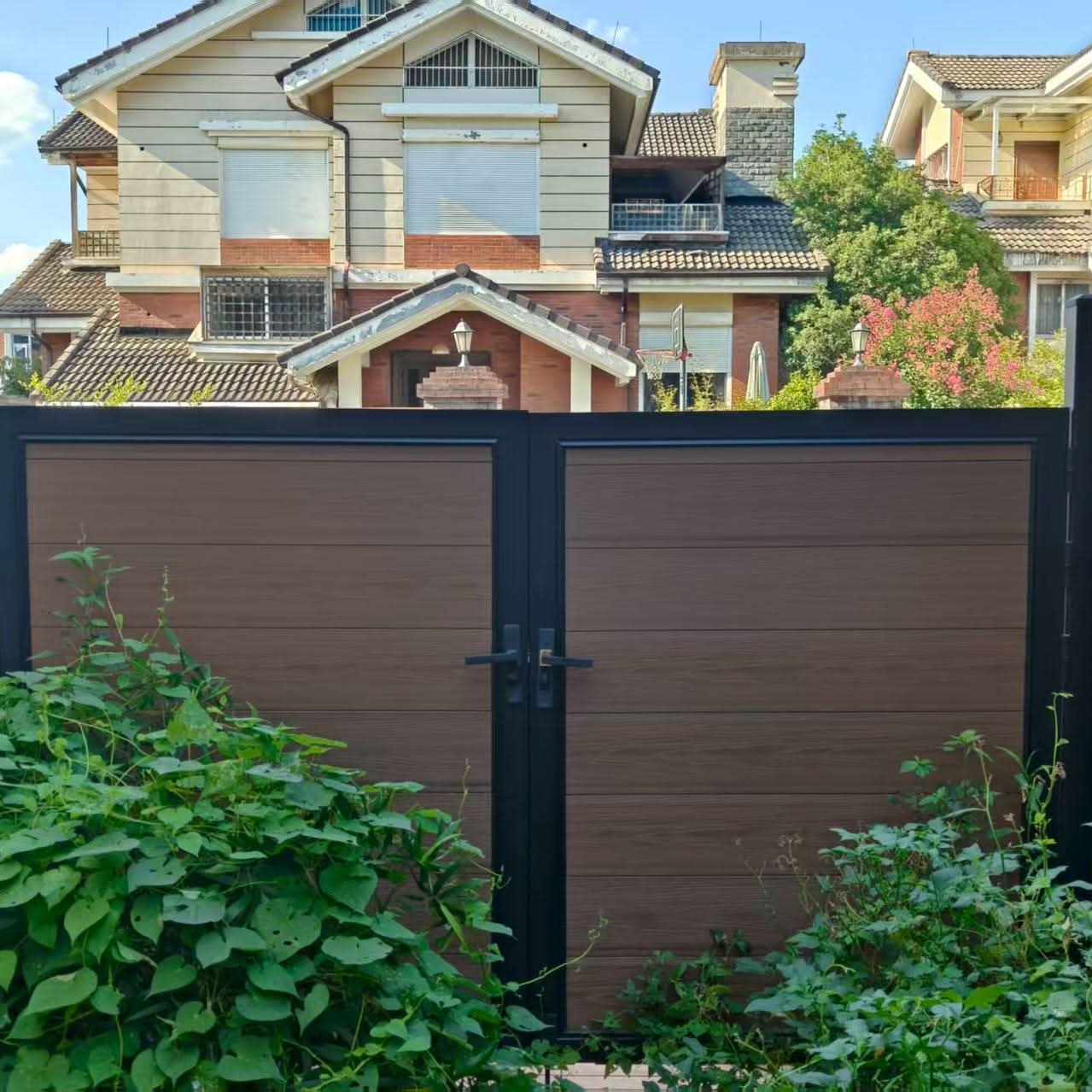 Brown composite double driveway gate with aluminum frame