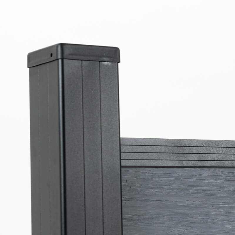 Close-up of a black capped post framing light gray composite fence boards