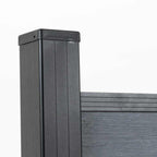 Close-up of a black capped post framing light gray composite fence boards