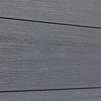 Close-up of light gray composite fence boards with horizontal wood-grain texture