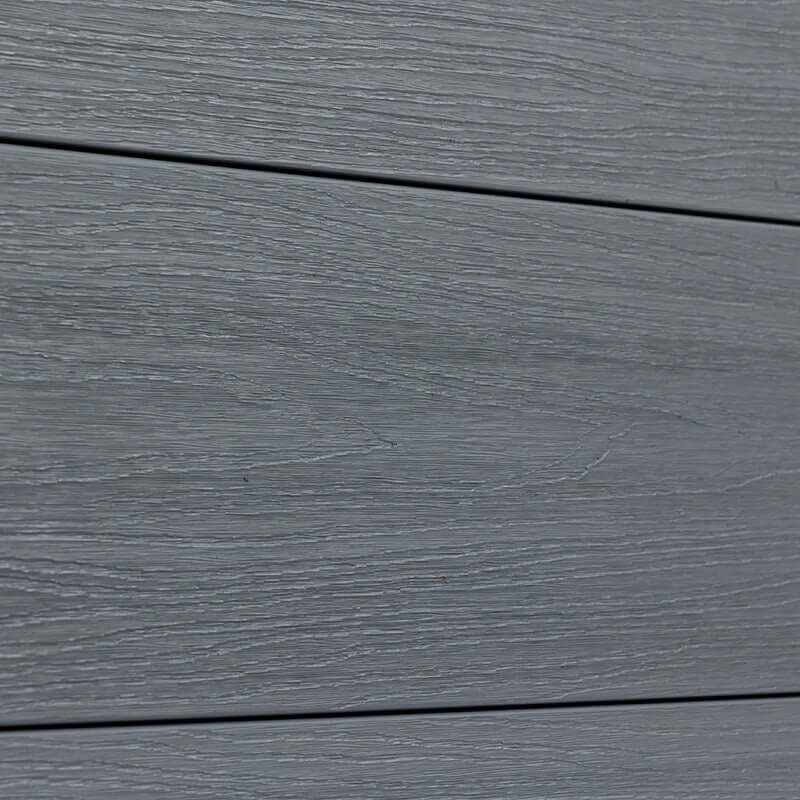 Close-up of light gray composite fence boards with horizontal wood-grain texture