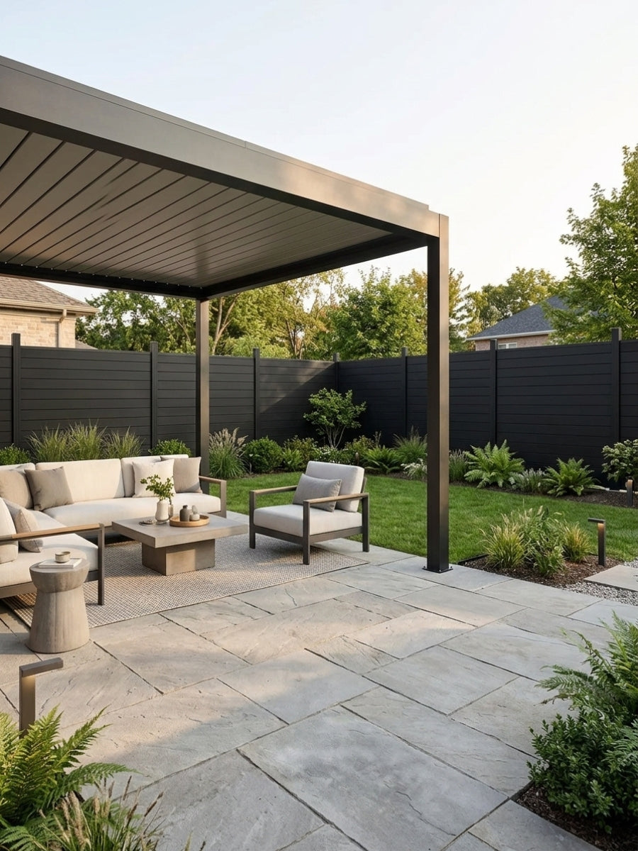 Black aluminum privacy fence surrounding a landscaped patio with pergola and outdoor seating