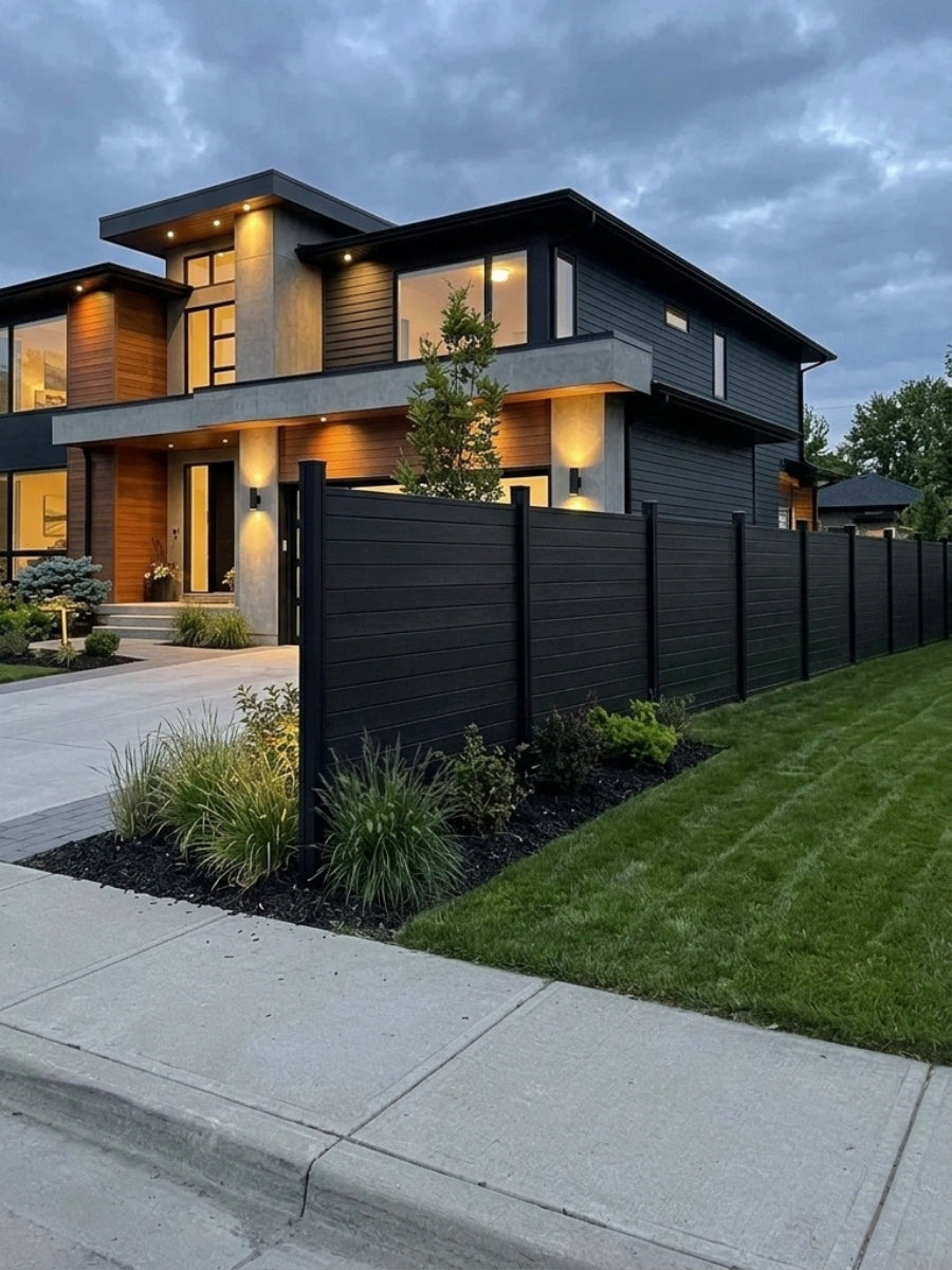 Black horizontal aluminum fence installed along the front lawn of a modern two-story home