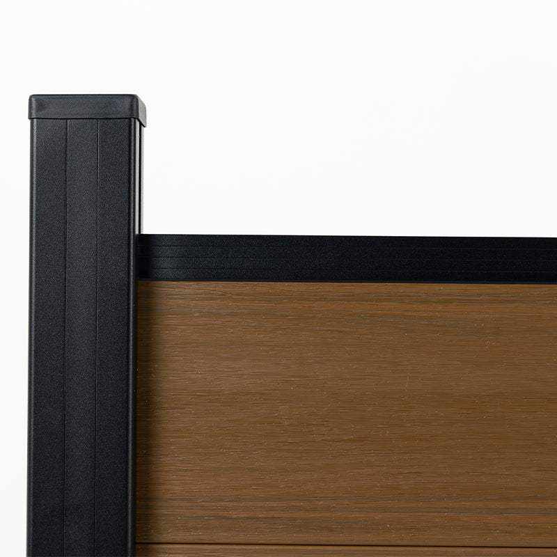 Side detail of wood-grain composite privacy fence panel with black aluminum post