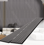 Black fluted wall panel installed as modern interior accent wall with vertical slat design