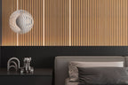 Fluted wood wall panels with integrated vertical LED strip lighting behind modern bed headboard