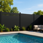 Black composite privacy fence with decorative top panel installed around modern backyard pool area