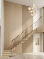 Light Nordic birch wood veneer panels with vertical slatted detailing installed along a modern staircase wall