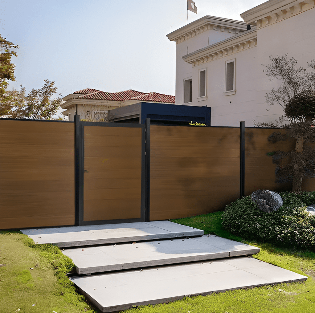 Brown composite fence gate with aluminum posts installed in modern residential landscape