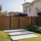 Brown composite fence gate with aluminum posts installed in modern residential landscape