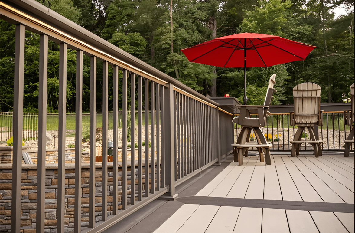 Brown composite railing kit with durable, low-maintenance design on a deck surrounded by trees in New Jersey Main image