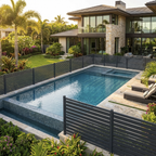 Light gray composite horizontal fence surrounding modern backyard swimming pool