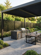 Open slat aluminum fence installed around a modern outdoor kitchen and dining patio