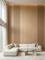 Floor-to-ceiling white oak veneer wall panels with fluted detailing behind a cream sectional sofa