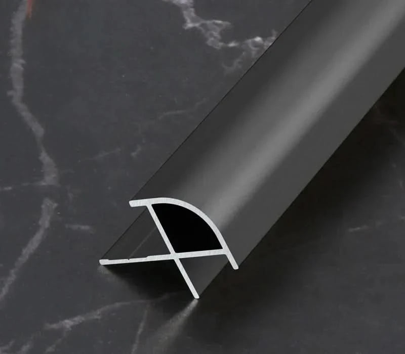 Black aluminum wall panel outside corner trim profile showing cross-section design, durable metal edge strip for modern interior wall panels