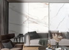 Modern living room with beige marble wall panels and soft gray seating