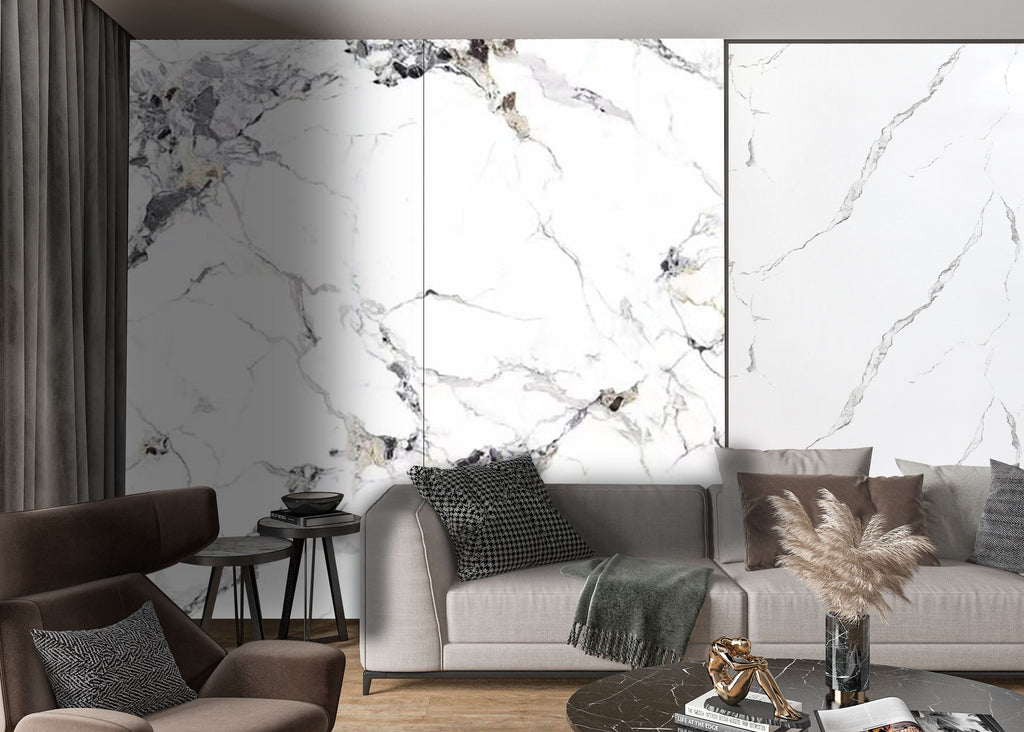 Modern living room with white marble wall panels, gray sofa, and warm neutral decor