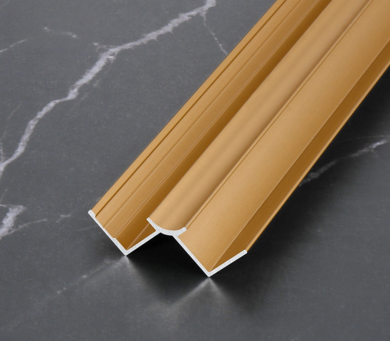 Gold 3mm aluminum inside corner trim profile angled on dark marble