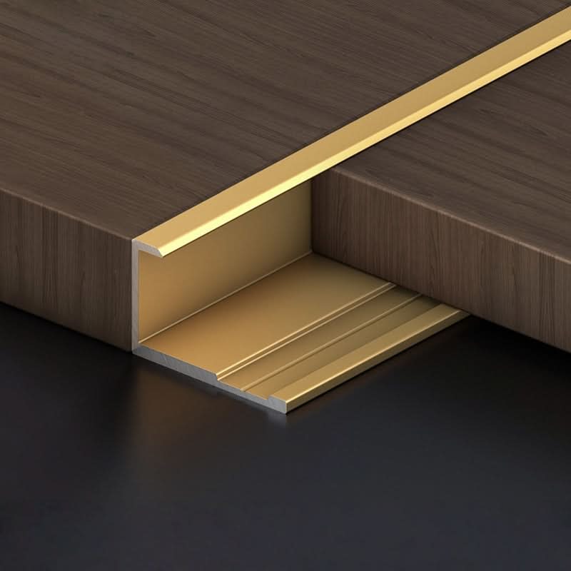 Gold aluminum wall panel L trim cap installed between wood panels for luxury edge finishing