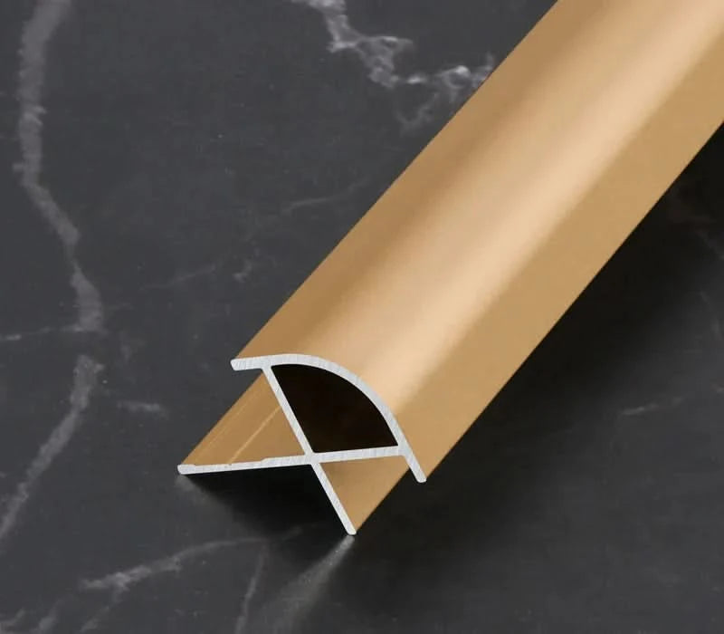 Gold aluminum wall panel outside corner trim with rounded profile, metal edge strip cross-section for modern wall panel installations
