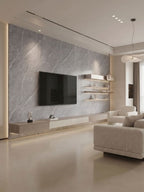 Modern living room with an ash gray marble PVC feature wall, mounted TV, floating shelves, and neutral seating