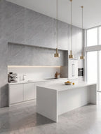 Ash gray marble PVC wall panels installed on an accent wall in a modern white kitchen